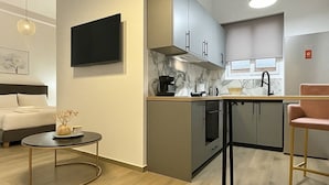 A modern kitchen with a built-in oven, a coffee maker, and a sink.