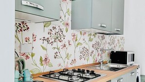 A modern kitchen with a gas stove, microwave, and built-in oven.