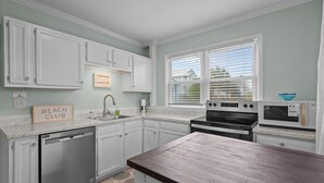 A kitchen with white cabinets, a dishwasher, an oven, and a microwave. - Low Tide at Coral Reef  2 BDRM  1.5 bath Sleeps 5 with Linens Included! (Carolina Beach)