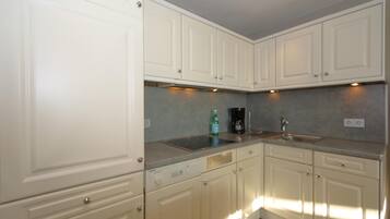 Coffee/tea maker, fridge, toaster, cookware/dishes/utensils