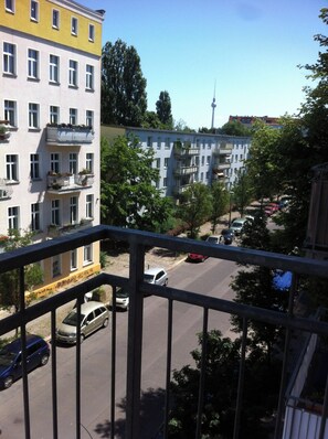 A multi-story building with balconies, a street with parked cars, and a clear sky. - Bright gorgeous Apt, heart of Berlin Mitte (126m2/Three spacious rooms+balcony) (Berlin)