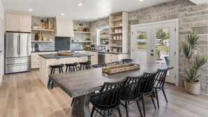 A modern kitchen with a central island, built-in appliances, and ample storage.