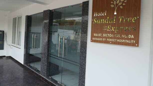 A hotel sign with the name 'Hotel Sandal Tree Express' and its address. - Hotel Sandal Tree Express (Noida)