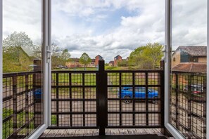 Enjoy a peaceful view of the surrounding neighborhood from this balcony.
