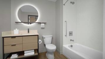 Un baño moderno con inodoro, lavamanos, tocador y bañera.