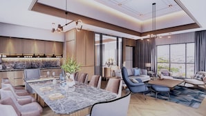 A modern interior with a dining area, sofas, and a large window offering a city view. - Four Points By Sheraton Pontianak (Pontianak)