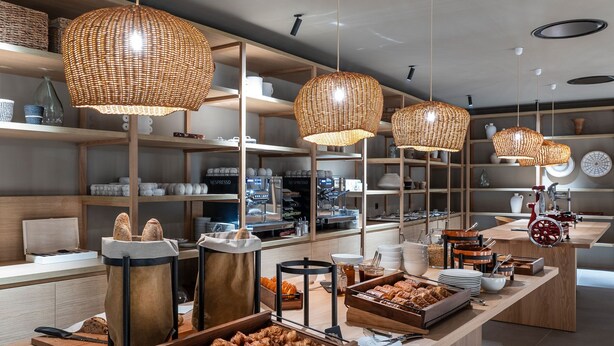 A bakery counter with pastries and coffee-making equipment. - Séjour chic avec accès au spa + piscine (Baillargues)