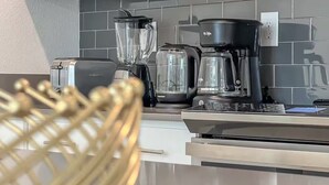 A modern kitchen with a blender, coffee maker, and toaster on the counter. - FL- 1042 Splash Shot (Davenport)