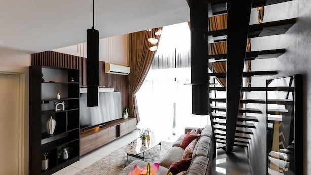 A modern living room with a sofa, coffee table, and shelves. - Premium Suite (Accra)