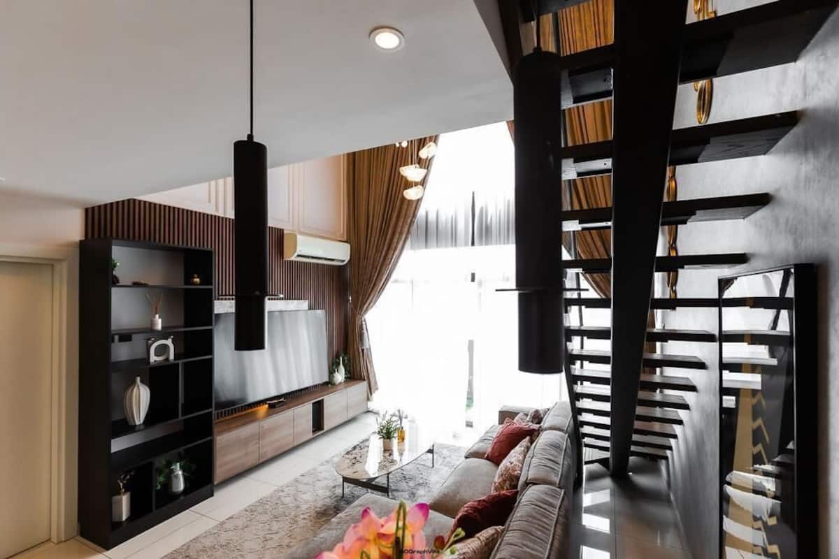 A modern living room with a sofa, coffee table, and shelves.