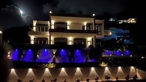 A modern multi-story building with a balcony, illuminated by exterior lights. - AZUR -  NEW SEA SIDE DR, 4 BR, 4.5 BA -  WALK TO  INDIGO BEACH (Sint Maarten)