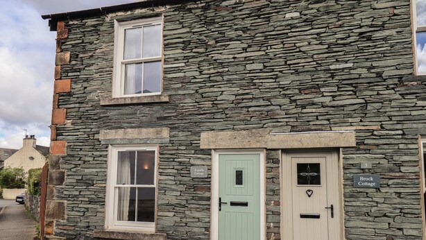 A stone building with two doors labeled "Capella Cottage" and "Brock Cottage." - Capella Cottage (Keswick)