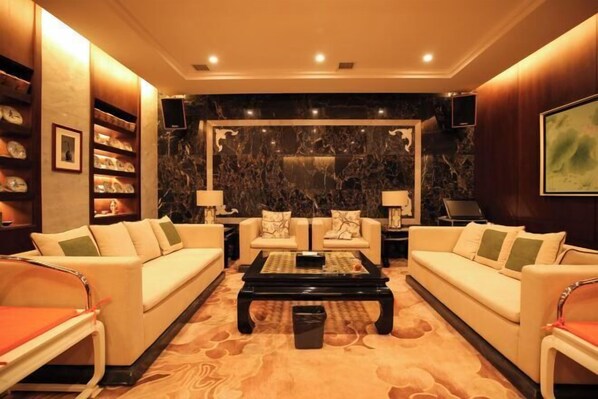 A spacious living room with two sofas, a coffee table, and a fireplace.