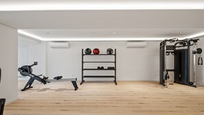 A gym with exercise equipment, a rowing machine, and a rack with sports balls. - Acqua s Bliss by Homie (Funchal)