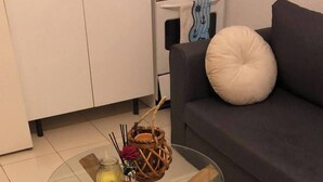 A glass-top coffee table with wooden legs, a woven basket, and a small vase with flowers. - Bungalow in La Marina Free Cancellation (San Fulgencio)