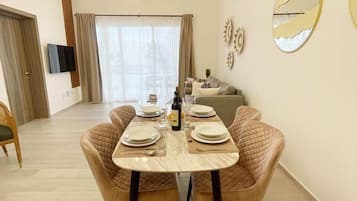 Deluxe Apartment, Balcony, Garden View | Living area | Flat-screen TV