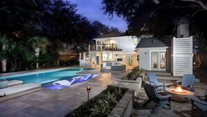 A two-story house with a swimming pool, outdoor seating, and a fire pit. - 3405 Cameron by Avantstay Pool, Outdoor Kitchen (Isle of Palms)