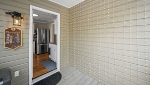 A kitchen with stainless steel appliances, a wooden backsplash, and a light fixture above the sink. - Precious 1-bedroom Cottage in Midtown Mobile Recently renovated with fenced yard (Mobile)