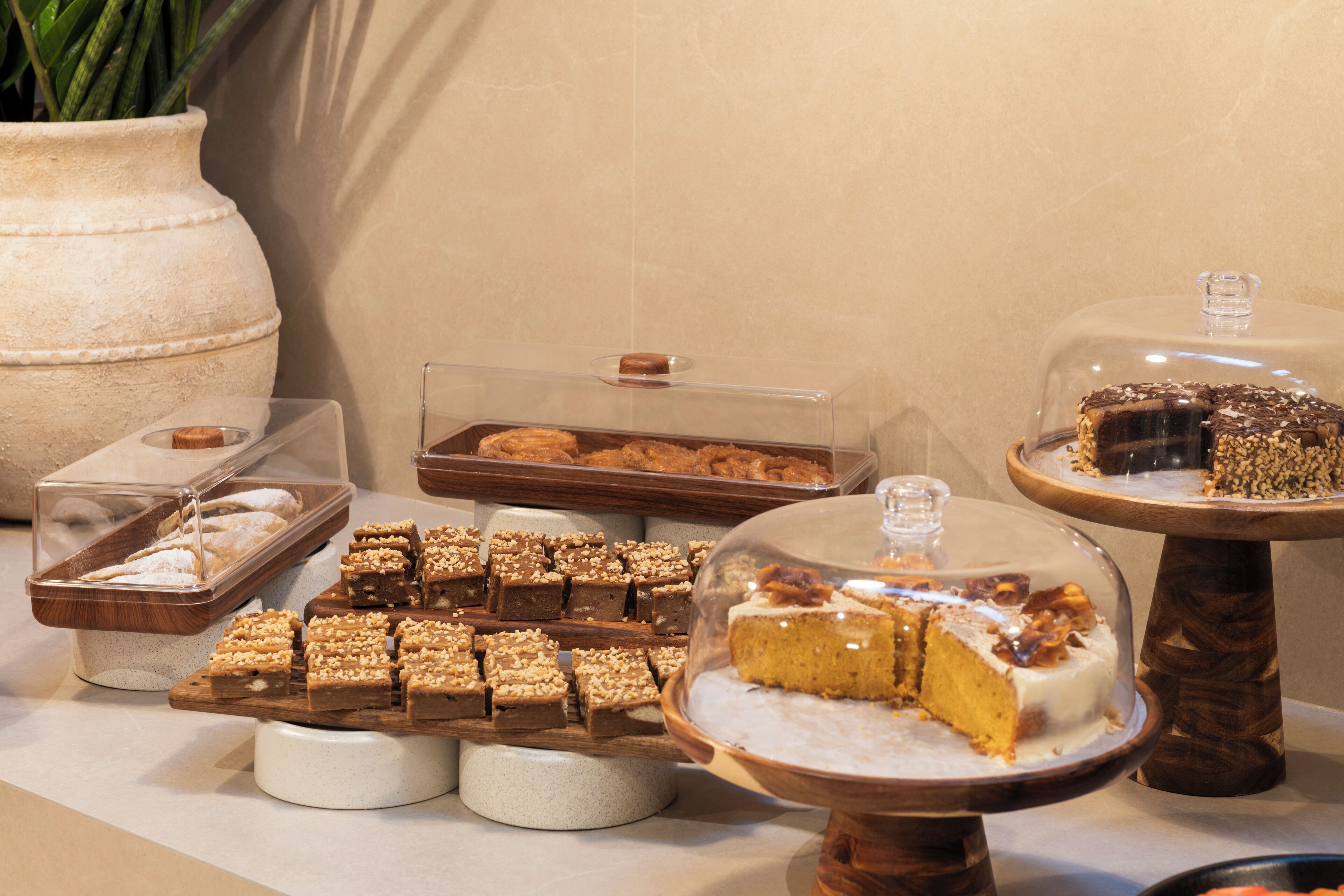 Une variété de desserts était présentée sur une table de buffet, notamment des brownies, des gâteaux et d’autres pâtisseries.