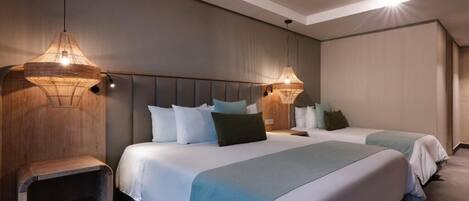 A hotel room with two beds, a wooden nightstand, and two wall-mounted lamps.