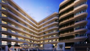 A multi-story hotel with a swimming pool, balconies, and outdoor seating. - Happy Travel Jade Tower (Fuengirola)