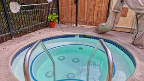 A swimming pool with a tiled edge and a metal ladder.
