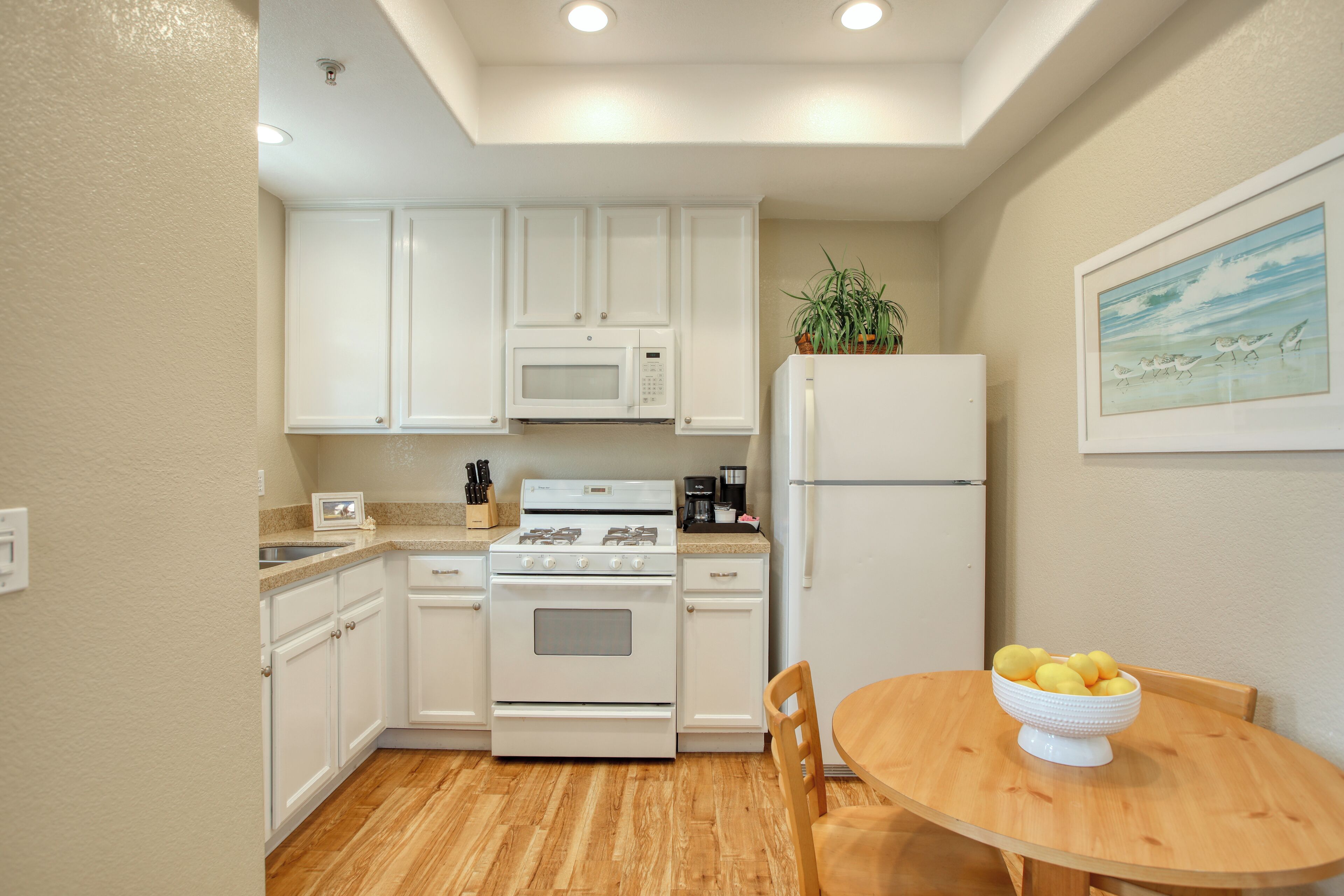 Fridge, microwave, coffee/tea maker, cookware/dishes/utensils