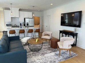 Relax in this stylish living space with a comfortable sofa, coffee table, and armchairs.