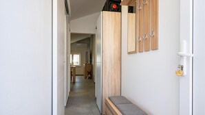 A hallway with a bench, wooden cabinets, and a coat rack. - Beautiful apartment in Gornji Karin with WiFi (Gornji Karin)