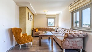 A cozy living room with a sectional sofa, a tufted armchair, and a wooden coffee table. - Awesome home in Pula with WiFi (Pula)