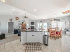 Enjoy meals in this kitchen with a large island, granite countertops, and a dining area with ocean views.