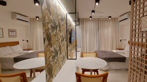 Une chambre d’hôtel avec deux lits, une petite table et un téléviseur.