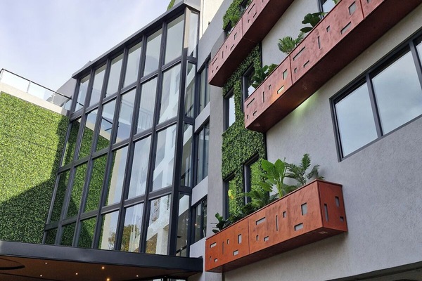 Admire green-lined balconies and contemporary lines from below.