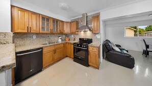 A kitchen with wooden cabinets, a built-in oven, and a dishwasher.