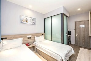 A hotel room with two beds, a wooden headboard, a glass partition, and a door with a sign. - Liru Tujia Hostel (Beijing)