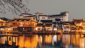 A traditional Chinese courtyard with buildings featuring classic architecture and a calm water body in the foreground. - Yixing Hotel (Shanghai Zhujiajiao Ancient Town Scenic Area Branch) (Shanghai)