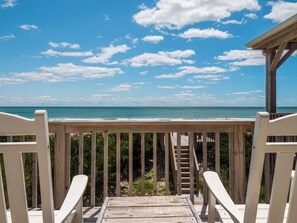 A wooden deck with a view of the ocean and beach. - Green Dolphin by Topsail Realty (Holly Ridge)
