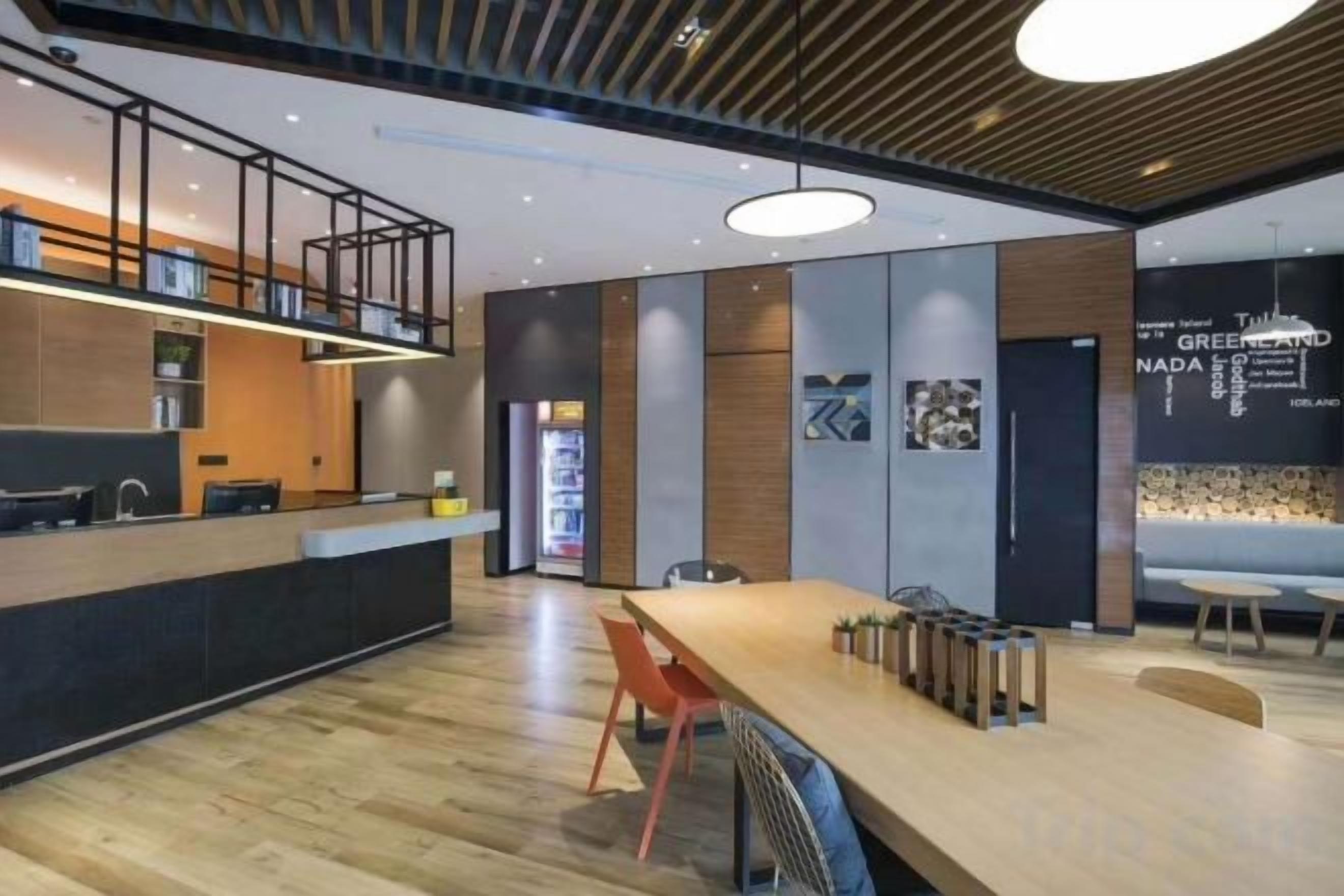 A modern kitchen with a wooden countertop and a built-in oven.