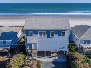 A two-story house with a dock, located near a beach. - Sweet Surrender by Topsail Realty (Holly Ridge)