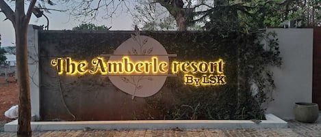 A sign for The Amberle Resort by LSK.