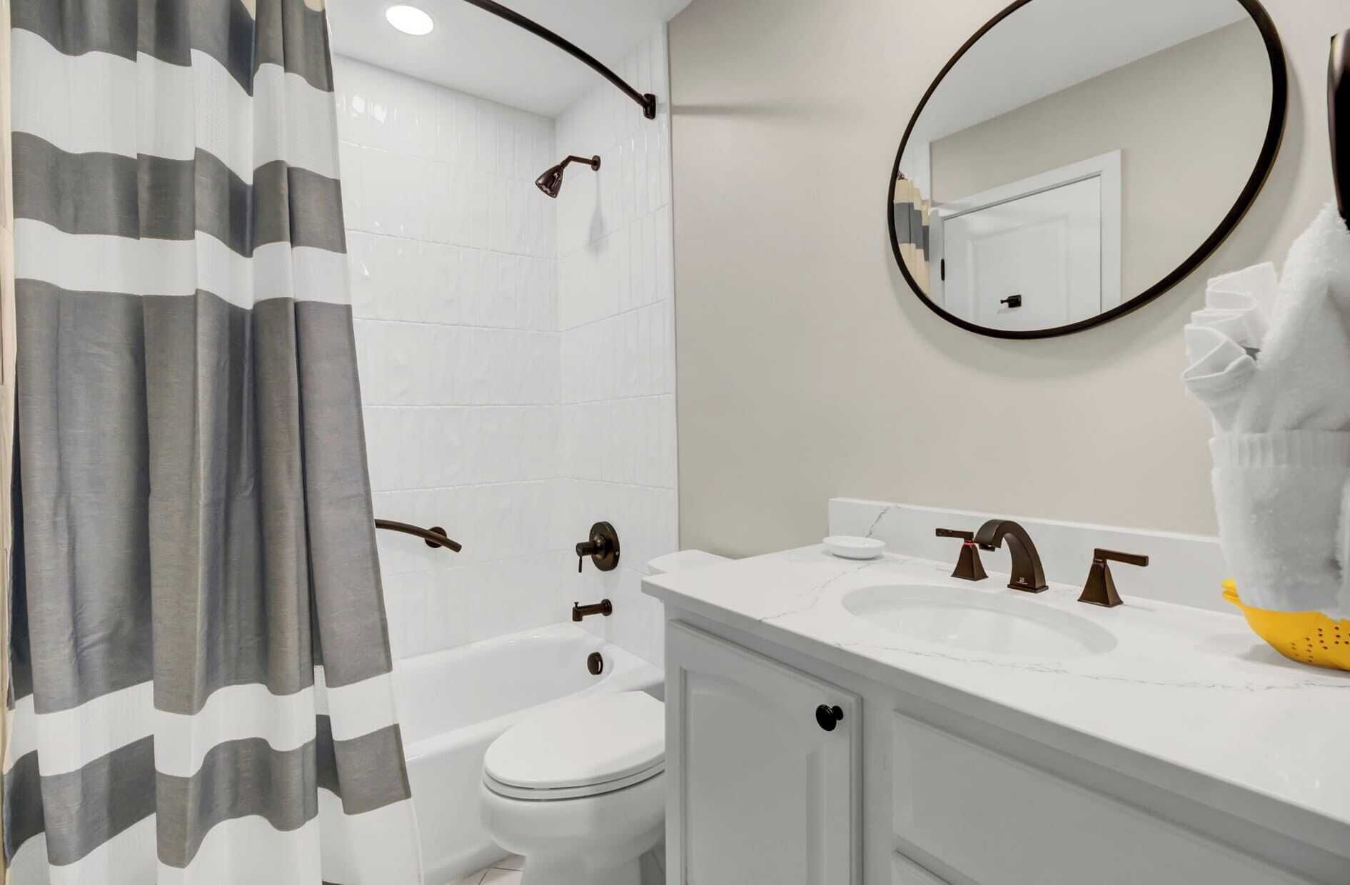 A bathroom with a shower, toilet, and sink.