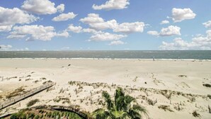 A beach with a wooden boardwalk and palm trees. - 518 Seascape Waterfront Views + Community Pool (Isle of Palms)