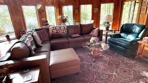 A cozy living room with a sectional sofa, a chaise lounge, and a coffee table.