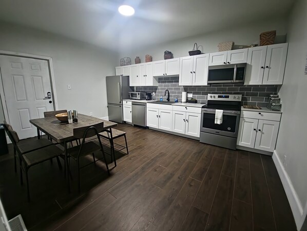 Prepare meals in the fully equipped kitchen with a refrigerator, microwave, and oven.