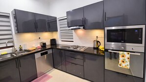 A modern kitchen with stainless steel appliances, a dishwasher, and a gas stove.