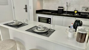 Fridge, microwave, stovetop, coffee/tea maker