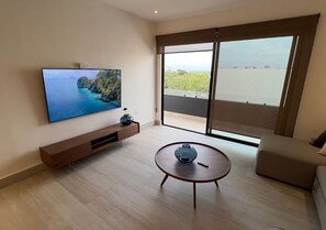 Family Apartment, City View | Living area | 65-inch flat-screen TV with digital channels - cumbres gardens (Cancún)