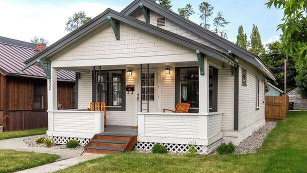 A single-story house with a front porch, a covered entryway, and a small front yard. - 30-Day Min, Walking Distance to Downtown & Lake + Nearby Whitefish Mountain Resort! (Whitefish)