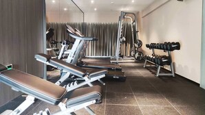 A modern gym with exercise equipment including treadmills, weight benches, and a squat rack. - Yuezhi Hotel Guangzhou Yuexiu Park (Guangzhou)