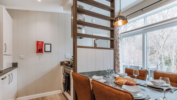 A modern kitchen with a dining area, wooden beams, and a large window. - 2 bedroom accommodation in Bridgnorth (Bridgnorth)